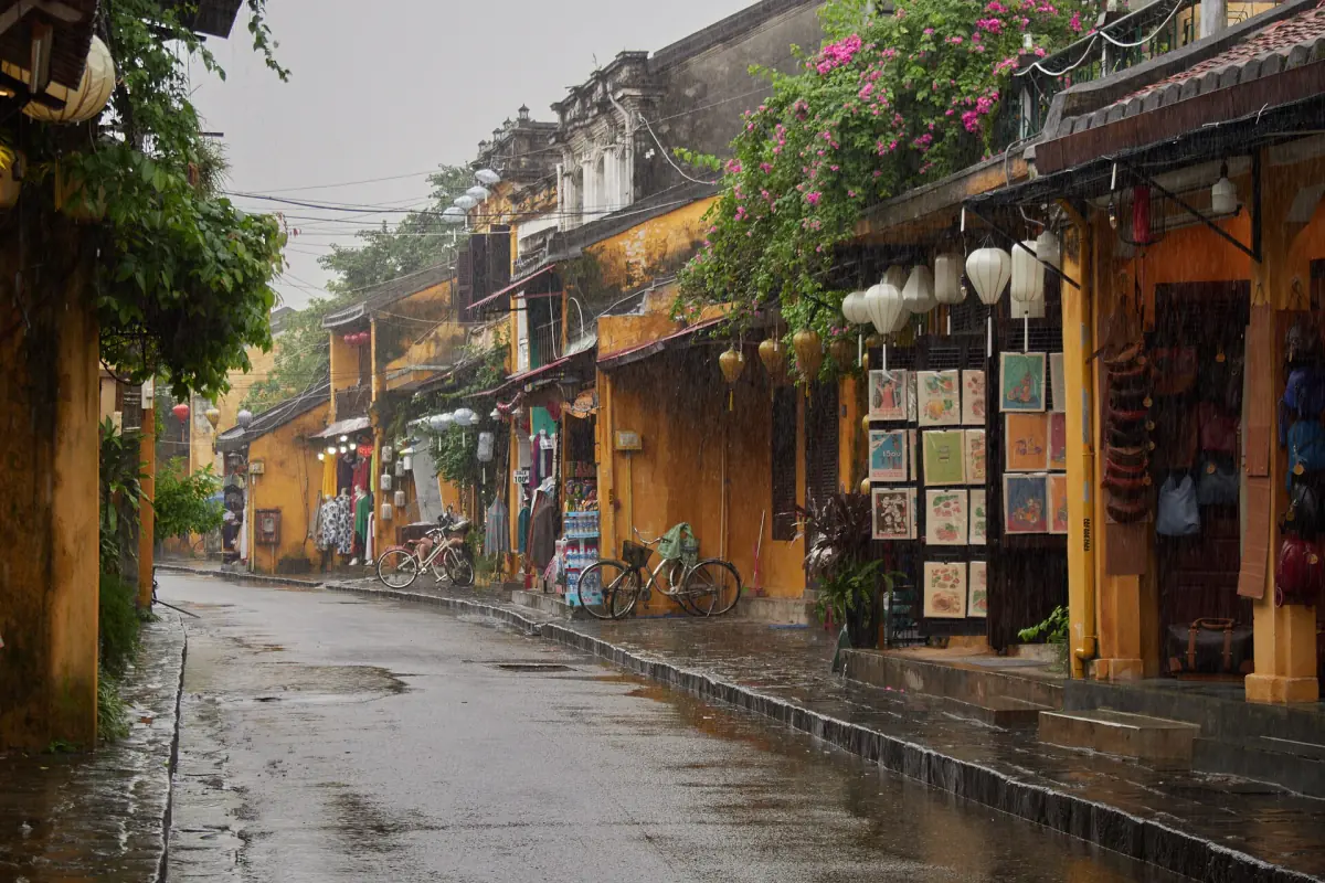 A quiet old town street with yellow houses after rain