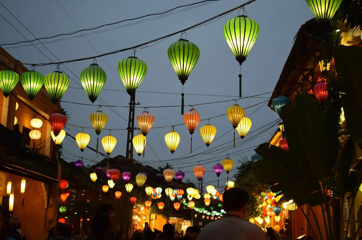 Green and orange lanterns hanging over a street