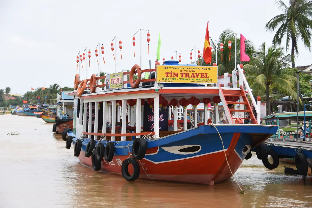A painted tourist boat moored in Hoi An